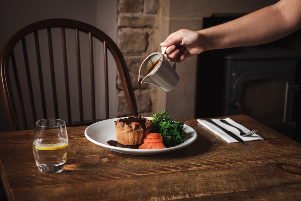 Pie in a pub with a gravy pour