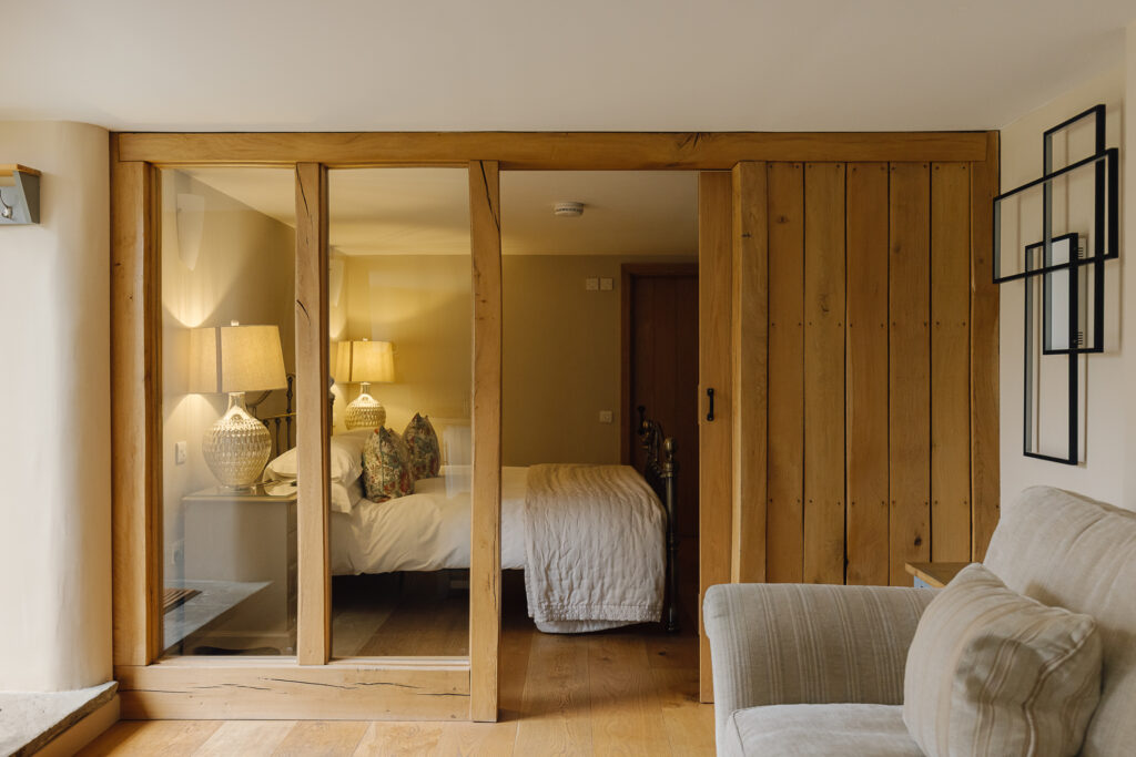 A bedroom through a beam frame.
