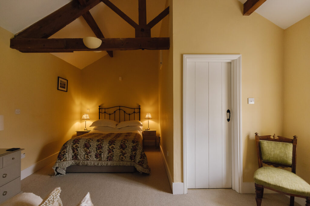 Large bedroom with double bed and warm lighting