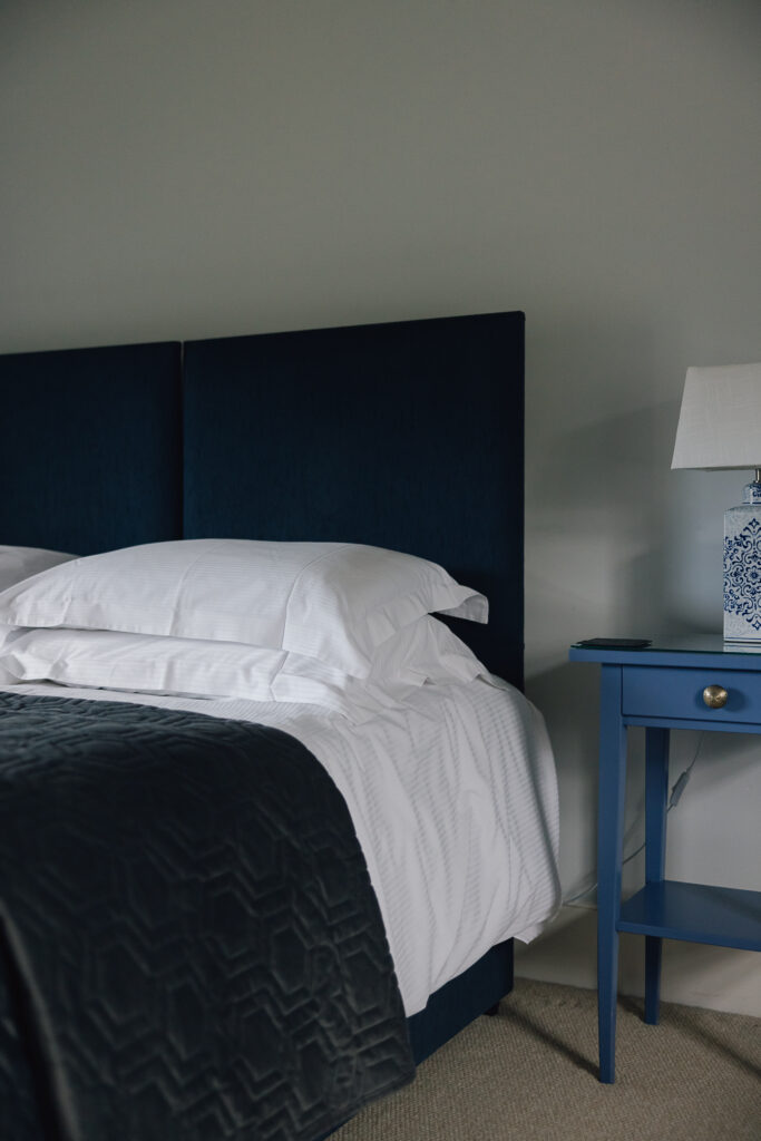 Comfortable bed with blue bed side table