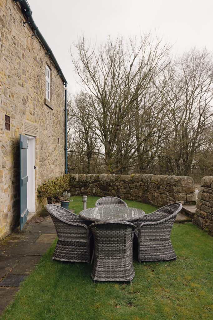 Outside area with rattan table and chairs on grass