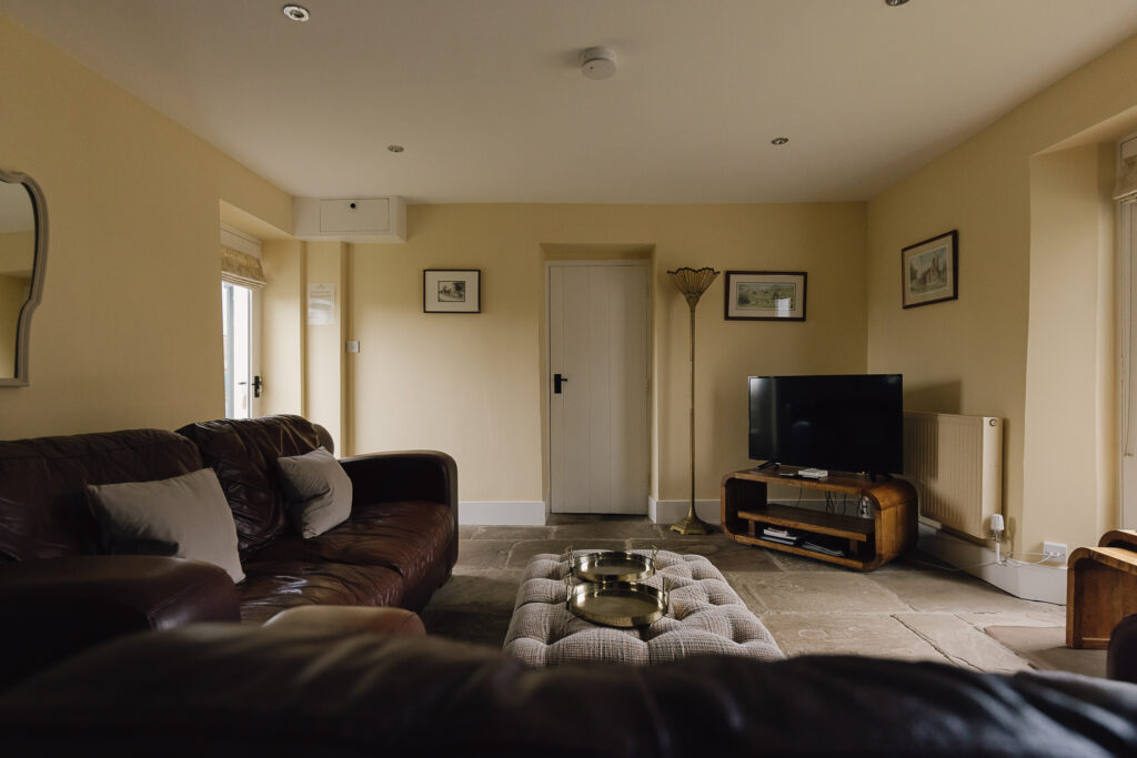 Two sofas and a footstool looking towards the tv