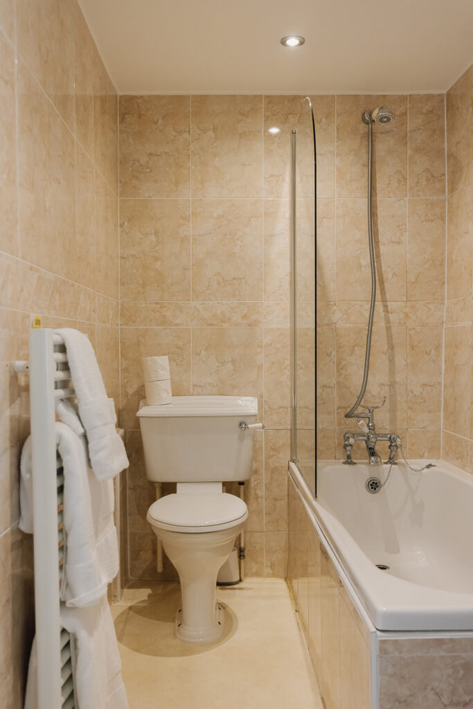 Bathroom with toilet and over head shower