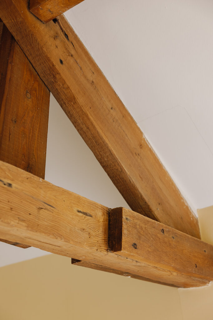 Rustic beam in bedroom