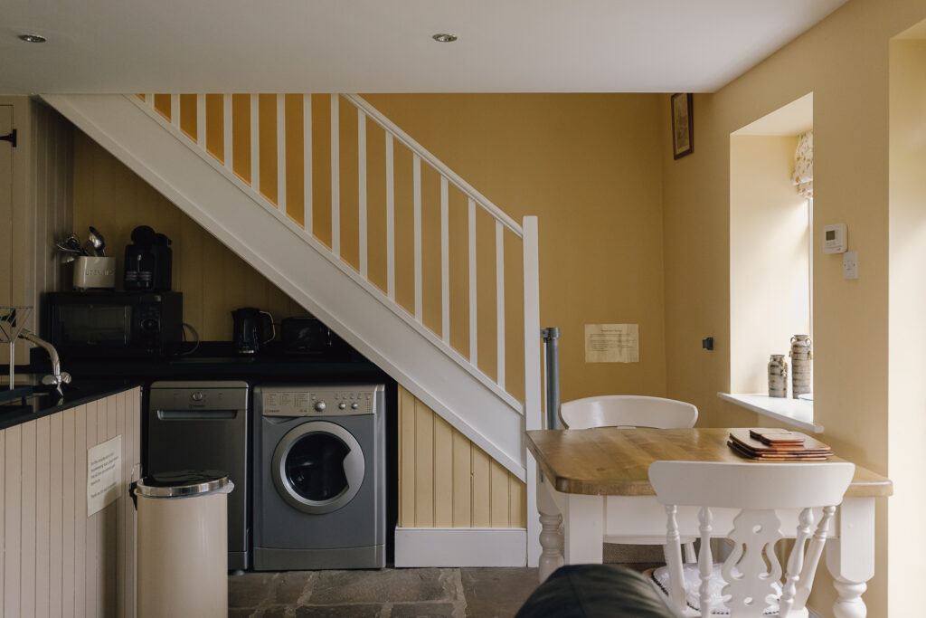 Kitchen area with stairs leading to the first floor