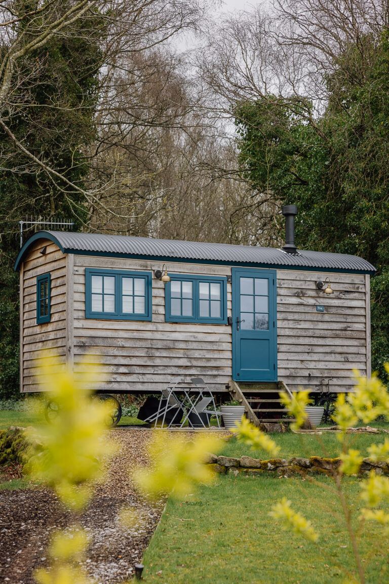 Green grass garden leading to a shepherds hut