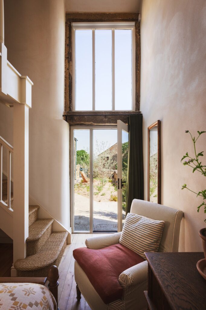 Striped armchair with door and view to the garden