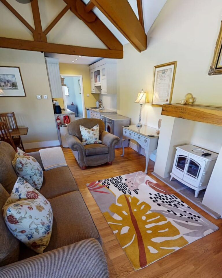 Living Room of Rowsley Cottage with sofas and brightly coloured rug