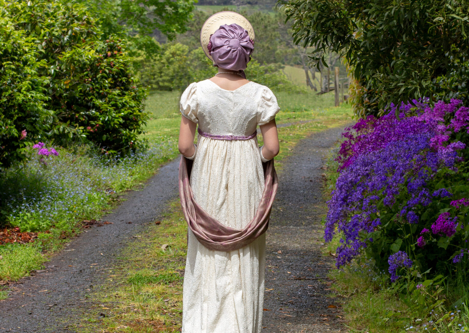 Regency woman in cream dress.