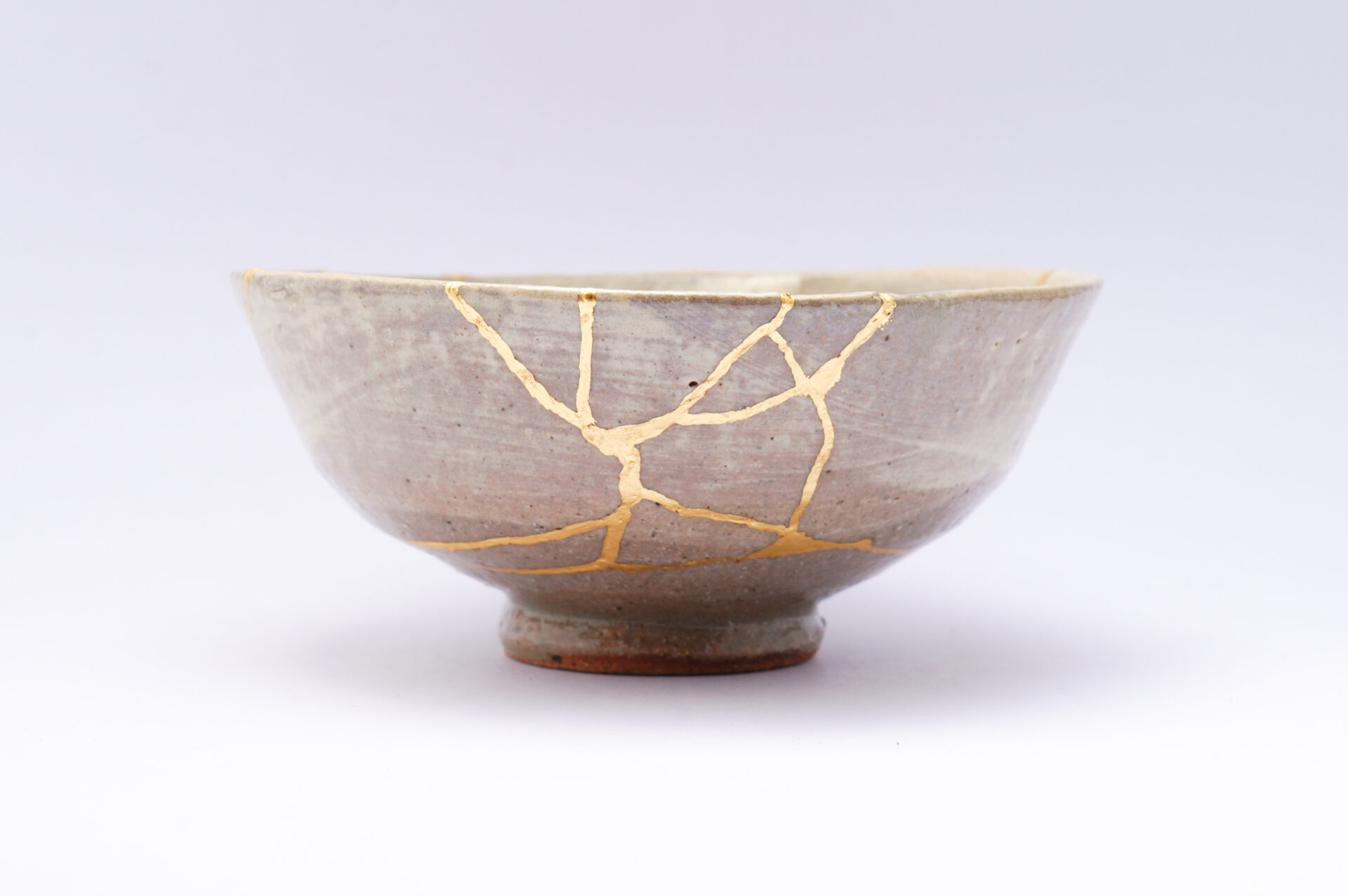 kintsugi bowl. Ceramic bowl with gold plating along its cracks.