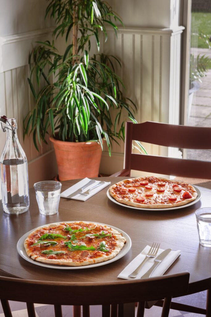 The Hide restaurant table setting with pizzas