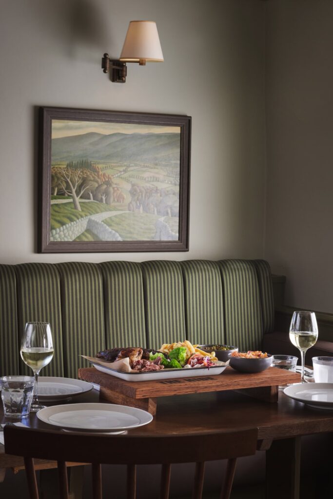 The Hide restaurant table with food and wine portrait