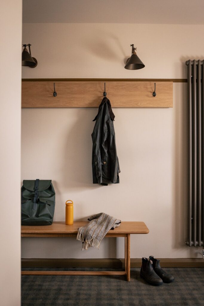 coat on a coatrack with a bag on a bench
