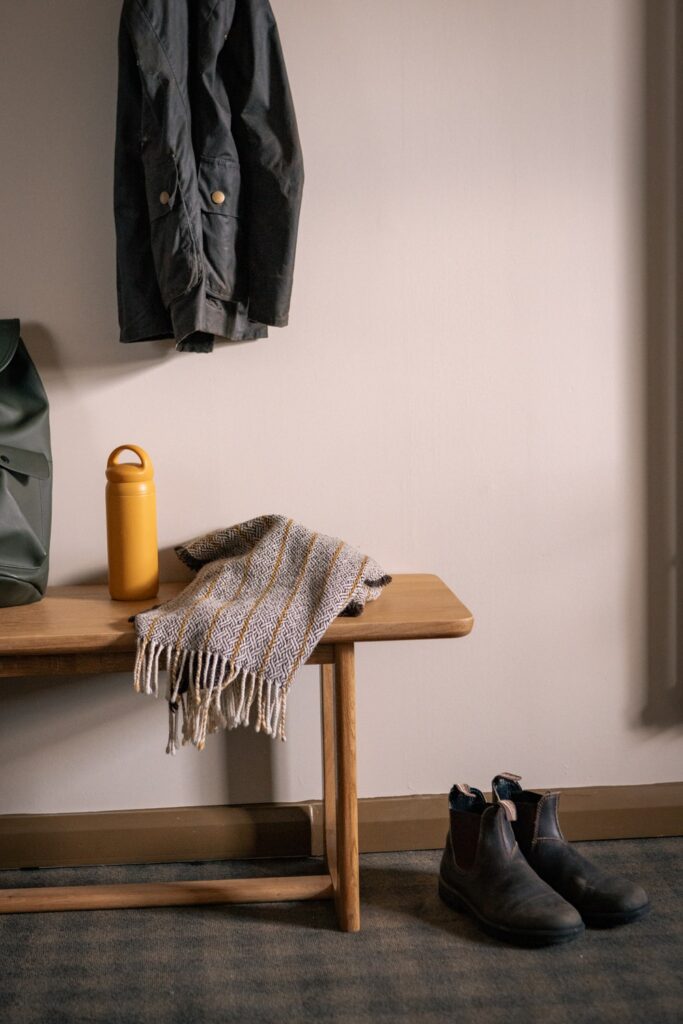 Boots, scarf, bottle, coat hung up