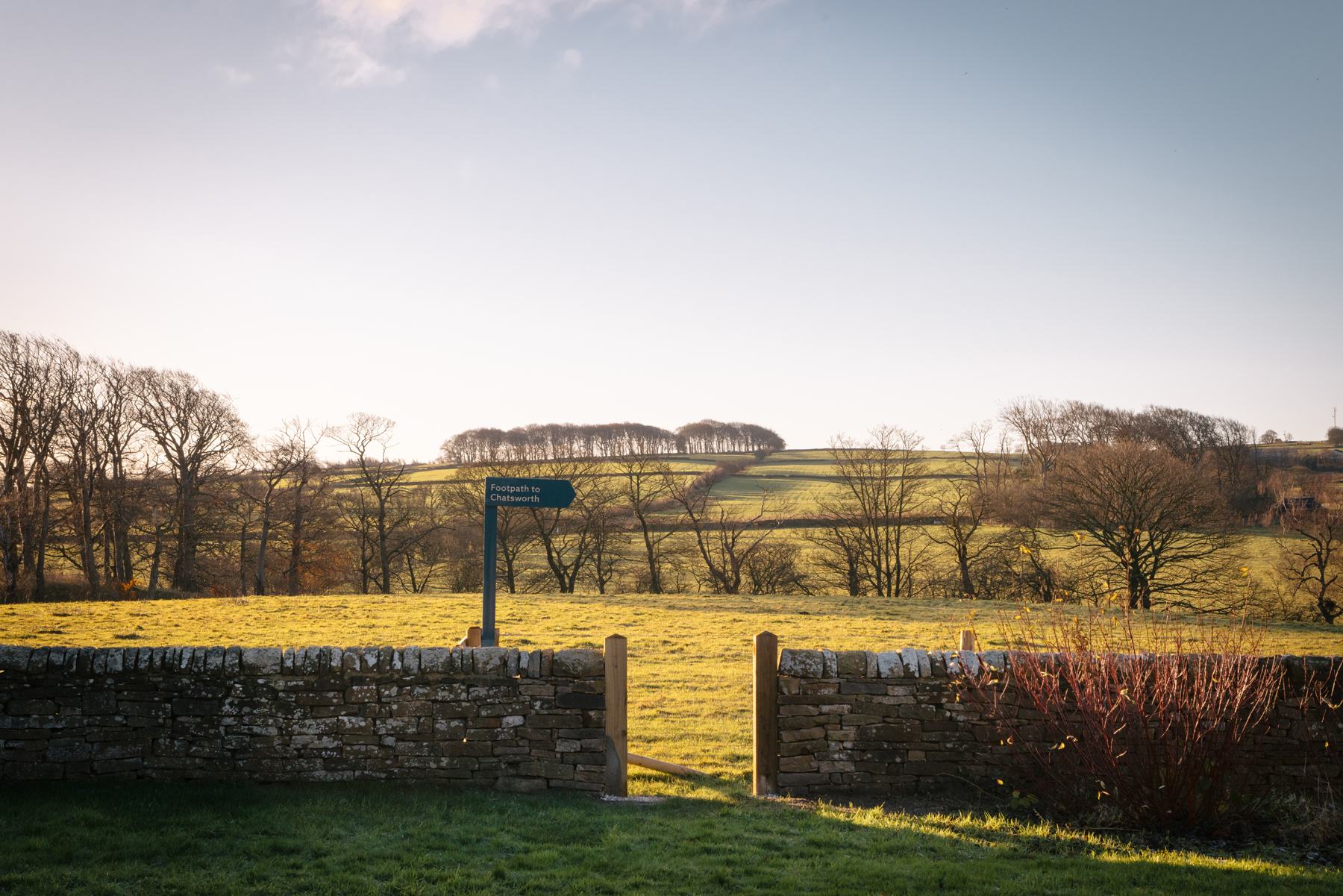 View from The Hide Hotel near Chatsworth House, with gate leading to a footpath across the Chatsworth Estate, surrounded by open countryside and greenery