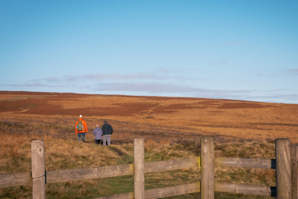 Family hiking through the moorland near the hide